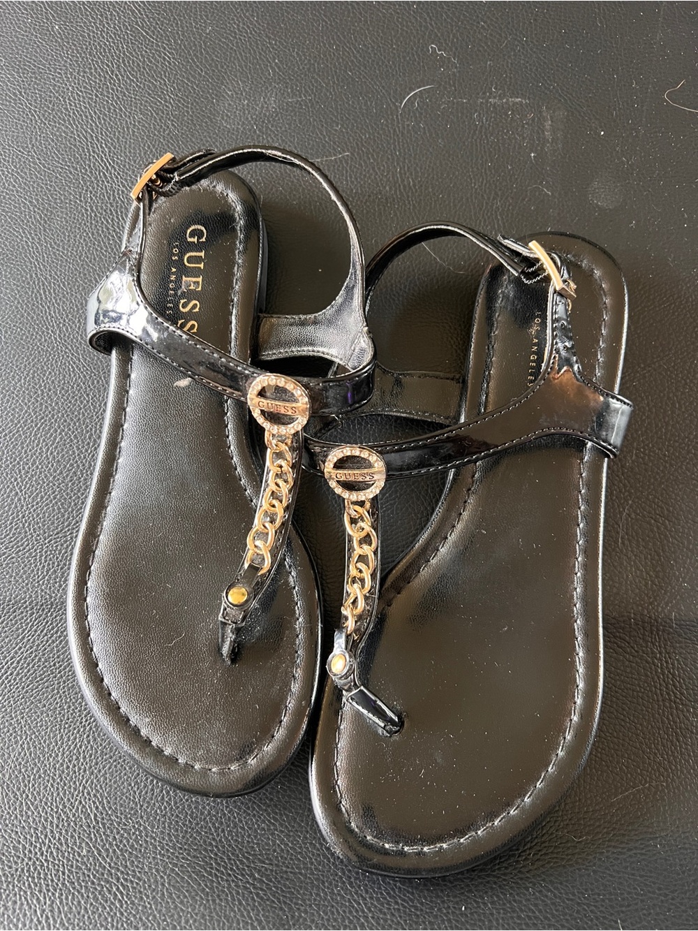 GUESS Black Patent Thong Sandals with Gold Chain Accents